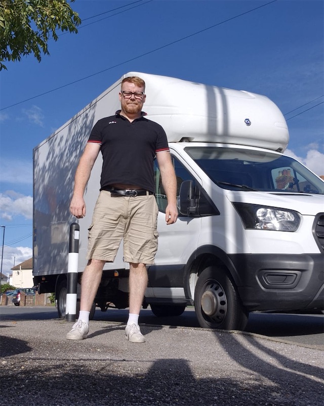Bartosz, a man with a van driver in Southampton, standing in front of his Luton van